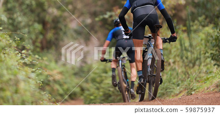 Mountain bikers riding on bike singletrack trail, mountain bike race Mountain bikers riding on bike singletrack trail, mountain bike race 59875937