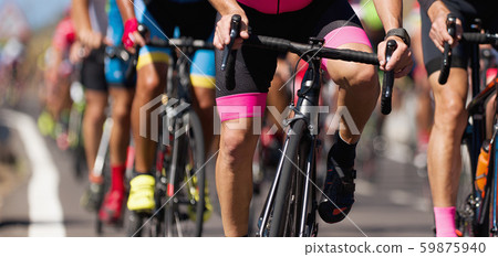 Cycling competition, cyclist athletes riding a race, climbing up a hill on a bicycle Cycling competition, cyclist athletes riding a race, climbing up a hill on a bicycle 59875940