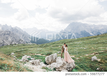 Just married couple kissing, mountains landscape on the background 59877277