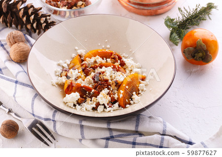 Winter dessert. caramelized persimmon with walnuts Winter dessert. caramelized persimmon with walnuts 59877627