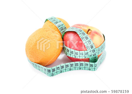 Measuring tape twisted around apples and oranges Measuring tape twisted around apples and oranges 59878159