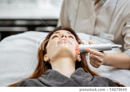 Woman during the facial treatment at the beauty salon Woman during the facial treatment at the beauty salon 59879640