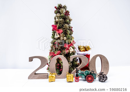 Beautifully decorated Christmas tree with a holiday party beginning in the new year and crossing to year 2020 Beautifully decorated Christmas tree with a holiday party beginning in the new year and crossing to year 2020 59880216