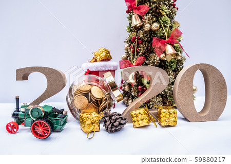 Beautifully decorated Christmas tree with a holiday party beginning in the new year and crossing to year 2020 Beautifully decorated Christmas tree with a holiday party beginning in the new year and crossing to year 2020 59880217