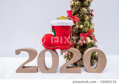 Beautifully decorated Christmas tree with a holiday party beginning in the new year and crossing to year 2020 Beautifully decorated Christmas tree with a holiday party beginning in the new year and crossing to year 2020 59880219