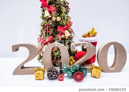 Beautifully decorated Christmas tree with a holiday party beginning in the new year and crossing to year 2020 Beautifully decorated Christmas tree with a holiday party beginning in the new year and crossing to year 2020 59880220