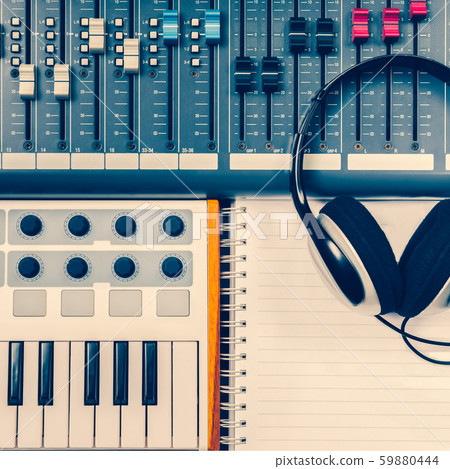 top view of audio mixing, mastering, recording, music production, sound engineering concept. part of audio mixing board, midi keyboard, headphone and paper on desk 59880444