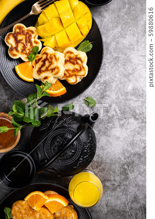 Healthy breakfast with fresh hot waffles hearts, pancakes flowers Healthy breakfast with fresh hot waffles hearts, pancakes flowers 59880616