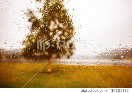 Driving a car in dodgy weather. View of the fjord through a wet window in the rain Driving a car in dodgy weather. View of the fjord through a wet window in the rain 59881182
