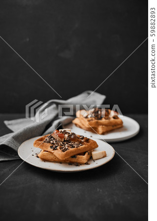 Homemade waffles with fruit and granola. 59882893