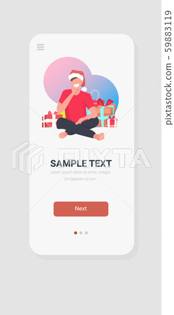 man in santa claus hat sitting near gift present boxes merry christmas happy new year winter 59883119