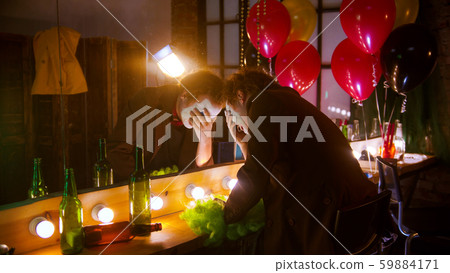 A sad man clown crying in front of the mirror A sad man clown crying in front of the mirror 59884171