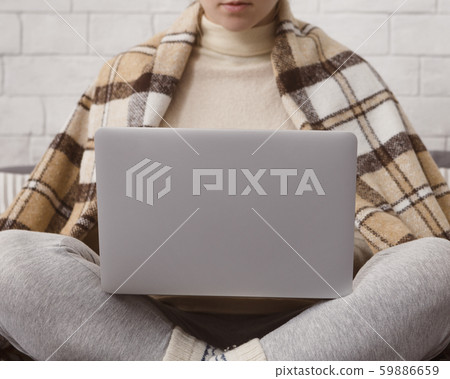 Close up of woman sitting at home and working on laptop Close up of woman sitting at home and working on laptop 59886659