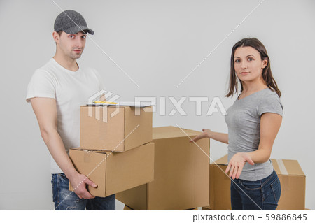 Young woman moving into new place, but she doesn't understand why delivery guy brought her two Young woman moving into new place, but she doesn't understand why delivery guy brought her two 59886845