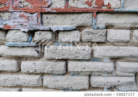 Multi-colored old brick walls of crumbling bricks 59887157