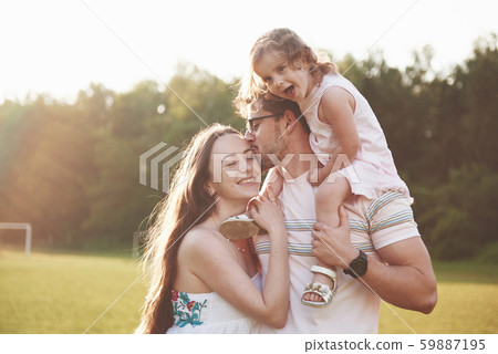 Happy family, father of mother and daughter of baby in the nature at sunset Happy family, father of mother and daughter of baby in the nature at sunset 59887195