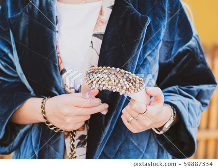 Outdoor close up portrait of a woman wearing stylish headband posing in street 59887334