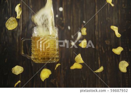 Falling beer and chips on a wooden wall 59887932