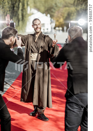 Film actor with photographers on the red carpet outdoors Film actor with photographers on the red carpet outdoors 59888757