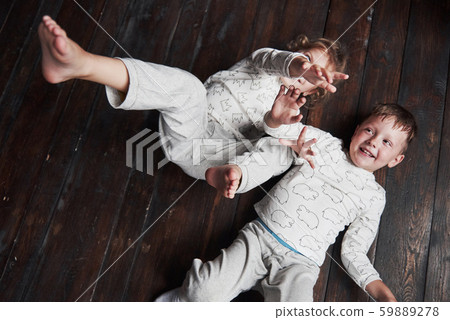Two children, brother and sister in pajamas play together 59889278