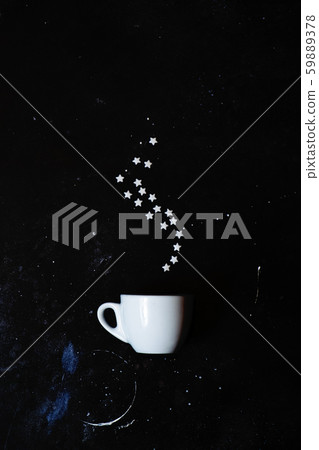 Creative coffee still life. Sugar stars laid out over cup in the form of steam. Creative coffee still life. Sugar stars laid out over cup in the form of steam. 59889378