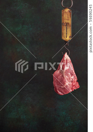 Pork steak on spring balance scale 59890245