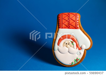 gingerbread cookie of winter glove with Santa's on 59890437