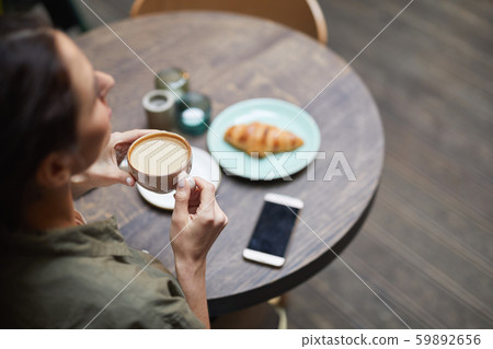 Above View of Young Woman Enjoying Coffee 59892656