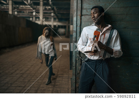 Frightened man hides from zombie, apocalypse 59892811