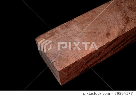 Logs of Burma Padauk wood beautiful pattern for crafts at the black background Logs of Burma Padauk wood beautiful pattern for crafts at the black background 59894177