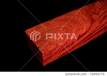 Logs of Burma Padauk wood beautiful pattern for crafts at the black background Logs of Burma Padauk wood beautiful pattern for crafts at the black background 59894179
