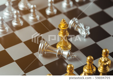 chess game gold king standing and silver chessboard, business strategy concept. chess game gold king standing and silver chessboard, business strategy concept. 59894705