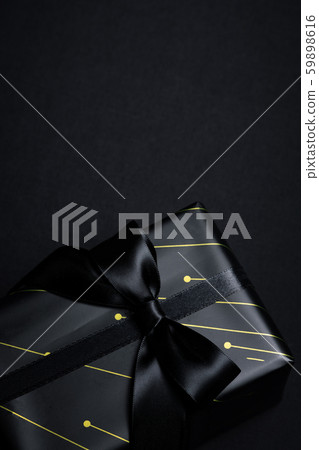 Top view of black gift box with black ribbons Top view of black gift box with black ribbons 59898616