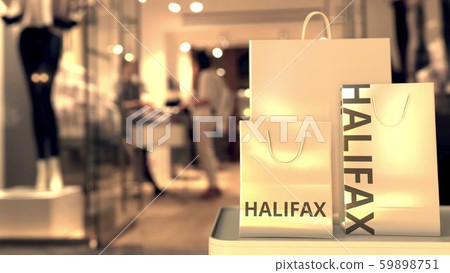 Shopping bags with Halifax caption against blurred store entrance. Shopping in Canada related 59898751