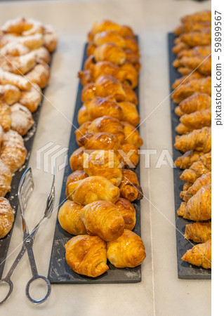 Closeup shot of mini croissant at banquet with beautiful arrangement 59899567
