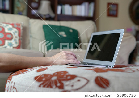 Woman typing on her laptop at her home. Work from Woman typing on her laptop at her home. Work from 59900739