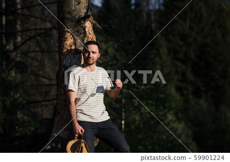 fine art portrait of a hipster man wearing sunglasses in a forest. 59901224