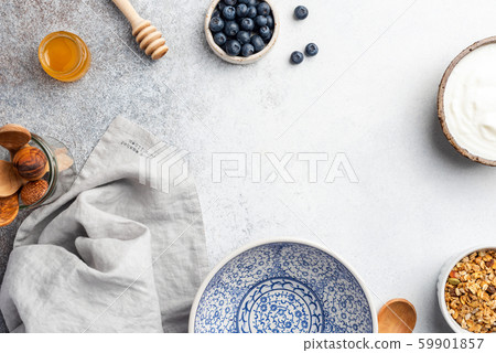 Breakfast Table with empty plate, yogurt, granola and berries Breakfast Table with empty plate, yogurt, granola and berries 59901857