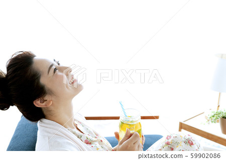 A woman relaxing on the sofa A woman relaxing on the sofa 59902086