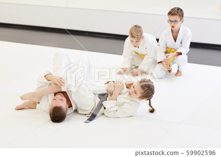 Boy fighting with girl at karate lesson 59902596