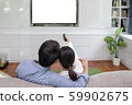 Back view of young family, man and woman watching 59902675