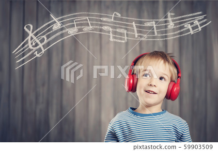 little boy on wooden background with red headphones little boy on wooden background with red headphones 59903509