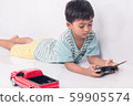 cute little boy play semi-automatic toy car on 59905574