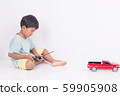 cute little boy play semi-automatic toy car on 59905908