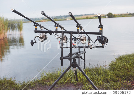 Carp fishing rods standing on special tripods. Expensive coils and a radio system of crochet 59906173
