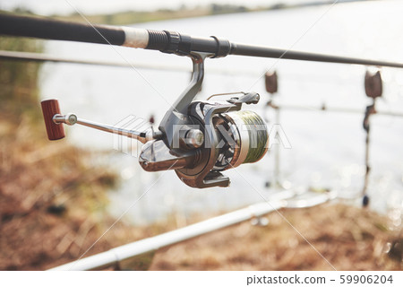 Carp fishing rods standing on special tripods. Expensive coils and a radio system of crochet Carp fishing rods standing on special tripods. Expensive coils and a radio system of crochet 59906204
