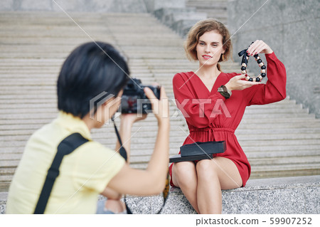Woman posing with massive necklac Woman posing with massive necklac 59907252