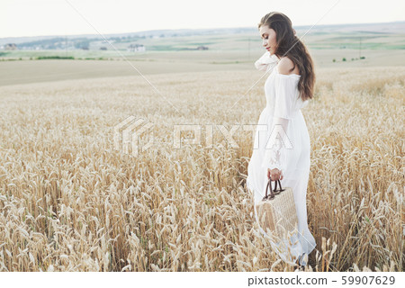 Beautiful girl in a field of wheat in a white dress, a perfect picture in the style lifestyle Beautiful girl in a field of wheat in a white dress, a perfect picture in the style lifestyle 59907629