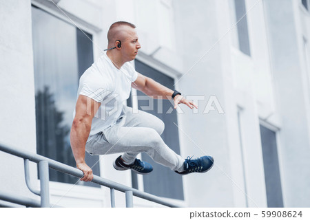 Young sports man doing parkour in the city Young sports man doing parkour in the city 59908624