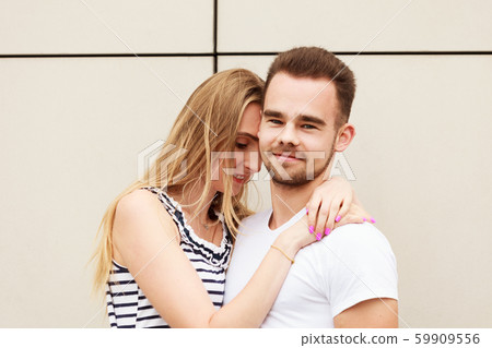 Blonde girl with her boyfriend outdoors. Blonde girl with her boyfriend outdoors. 59909556